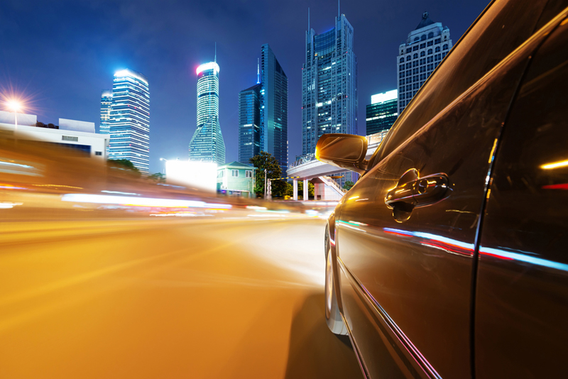 Car Entering City At Night